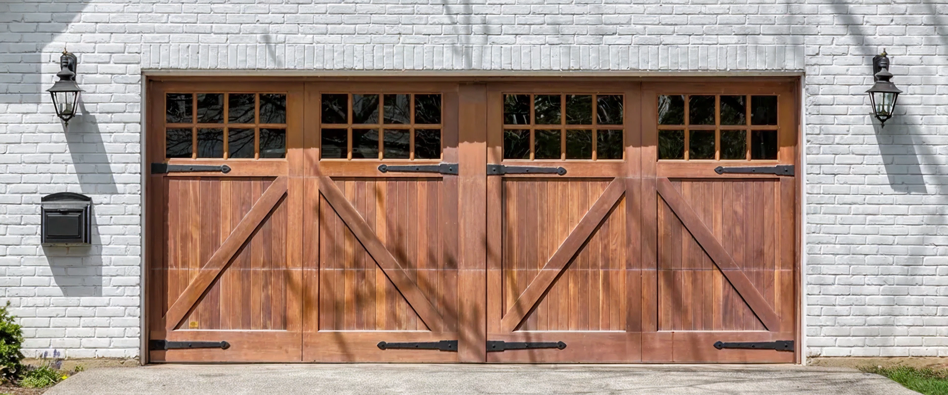 Wooden garage doors with brick wall