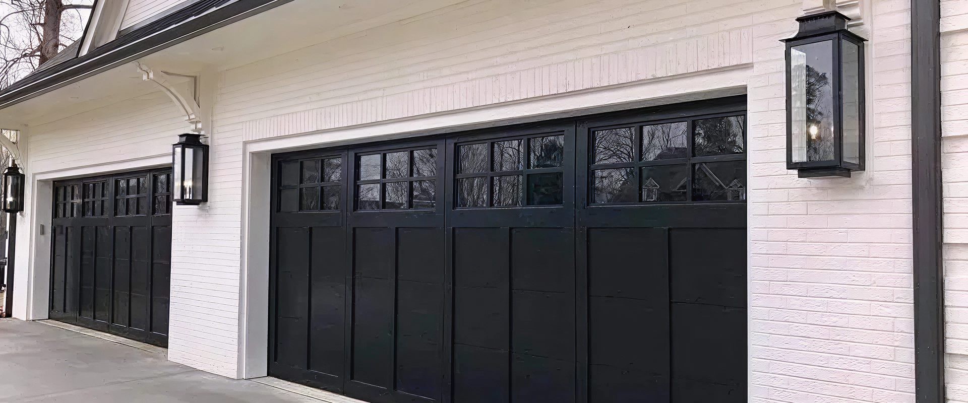 Modern black garage doors on white building